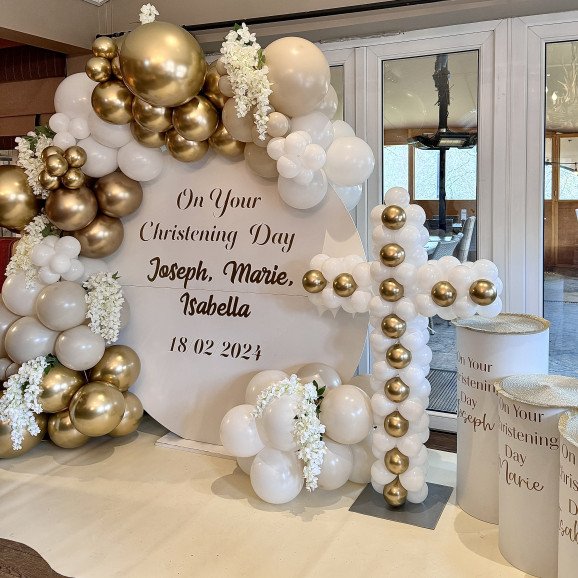 Amazing christening balloon decoration adorned with a cross made of balloons and a personalised backdrop.