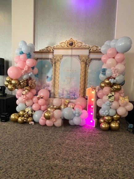 Our balloon technician and backdrop all made at home