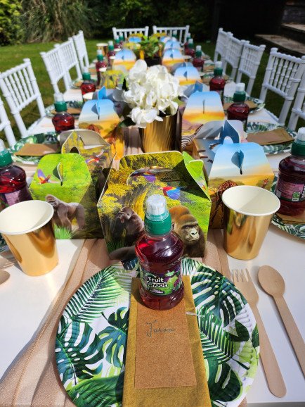 Kids table set up with lunch boxes and full themed styling