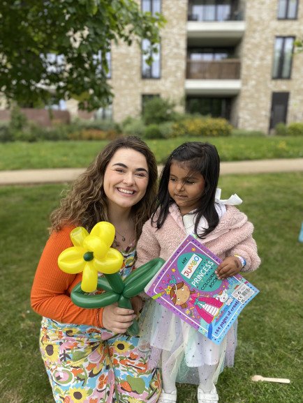 Birthday girl with her balloon and prizes