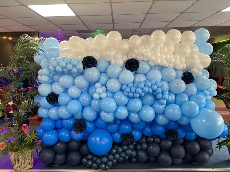 Elevate your event with this exquisite ombre balloon wall, a show-stopper, perfect for any celebration. 
Features:
•	Striking ombre design with high-quality balloons
•	Customizable floral embellishments 
Contact us to customize it to your event theme!