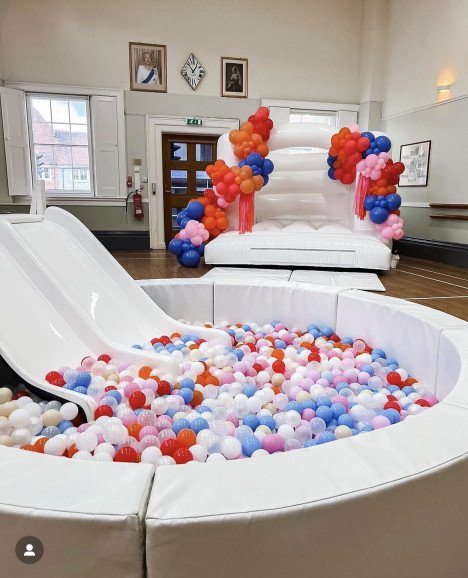 White bouncy castle and XL ball pool with double slide in Surrey and surrounding areas perfect for birthday parties, christenings, weddings and corporate events